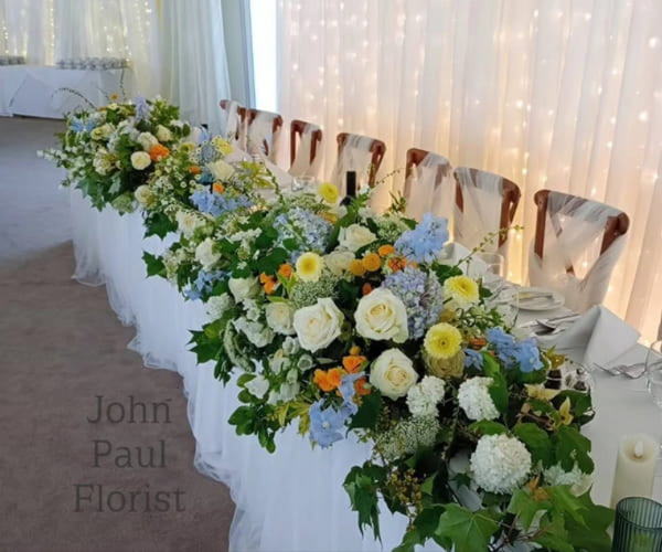 Wedding reception table flowers by John Paul Florist Milliner